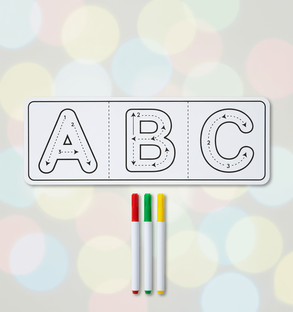 Letter tracing sheet with ABC and three markers on a blurred background