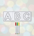 Letter tracing sheet with ABC and three markers on a blurred background